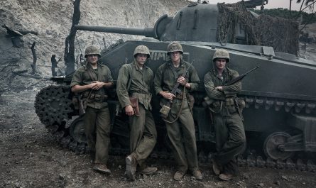 The Mosquito Bowl cast as Marines standing beside a tank